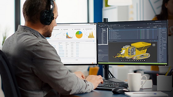 Professional uses Autodesk Vault PLM in office setting. 